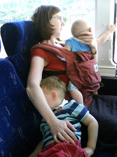Baby-wearing on a bus with an Ergo and a toddler