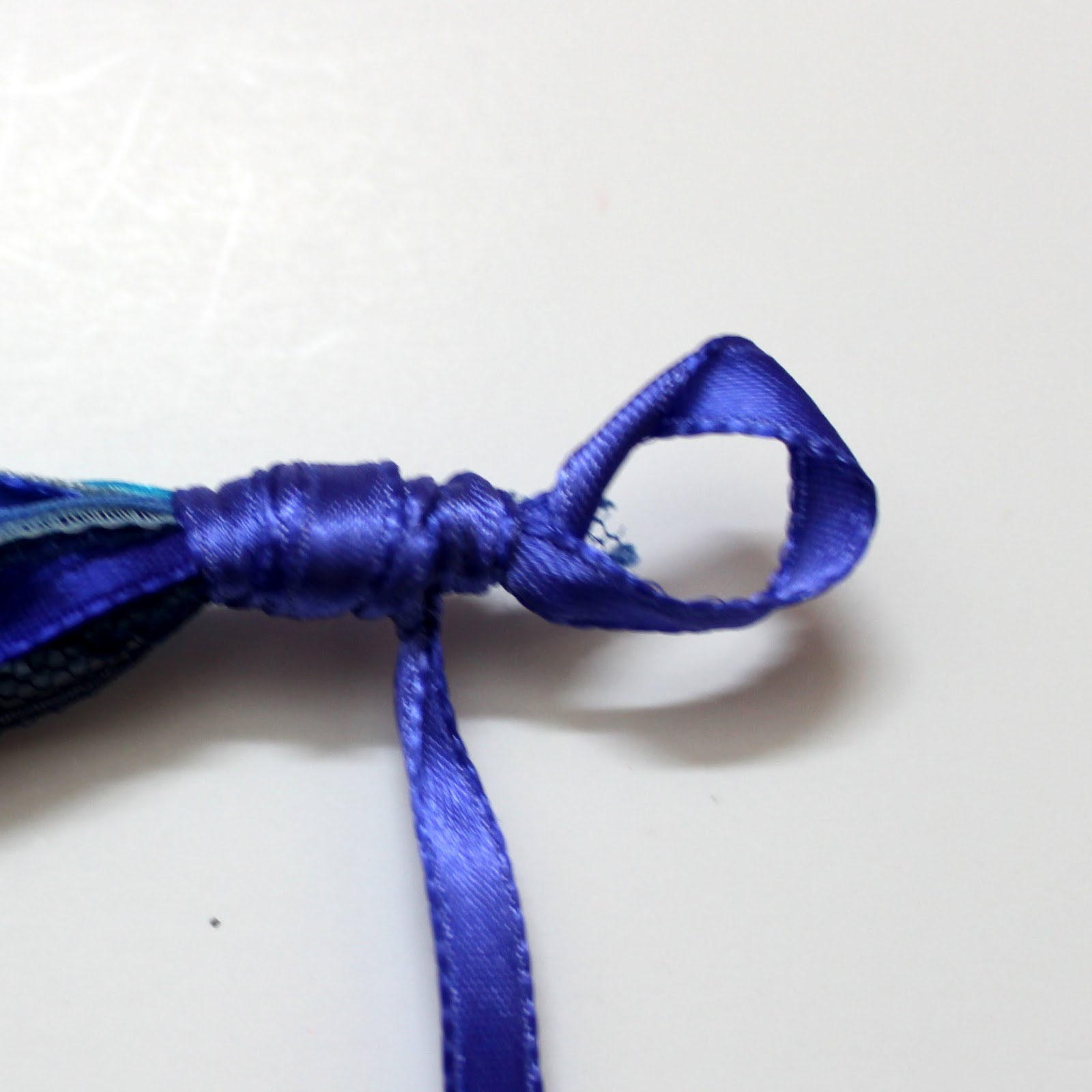 4. Wrap the satin ribbon around the knot multiple times.