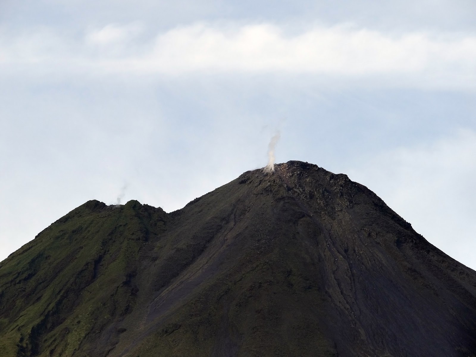 Love Goat Films A rainy hike on the picturesque Arenal Volcano's lava