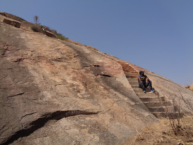 Madhu resting at the steep rock phase of medigeshi. Steps are carved to make the climb easy.