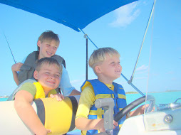 The Boys Navigating the Boat in the Harbor