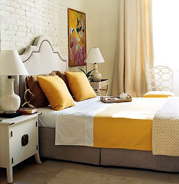 Yellow, brown & white bedding in the bedroom.