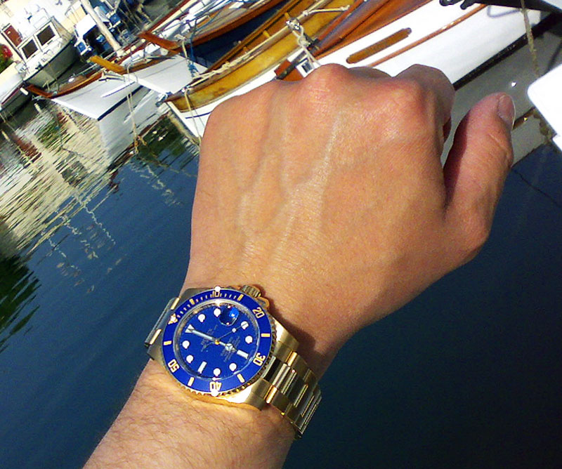 gold submariner on wrist
