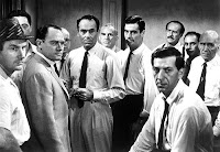 Scene of Twelve Angry Men with all jury members staring at the camera