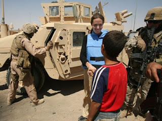 In this handout file photo, Angelina Jolie talks to an Iraq child August 28, 2007 at the Al Waleed refugee camp, Iraq. Jolie, the UNHCR goodwill ambassador, visted the refugee camp where at least 1200 people are living. (Jolie-Pitt Foundation via Getty Images)