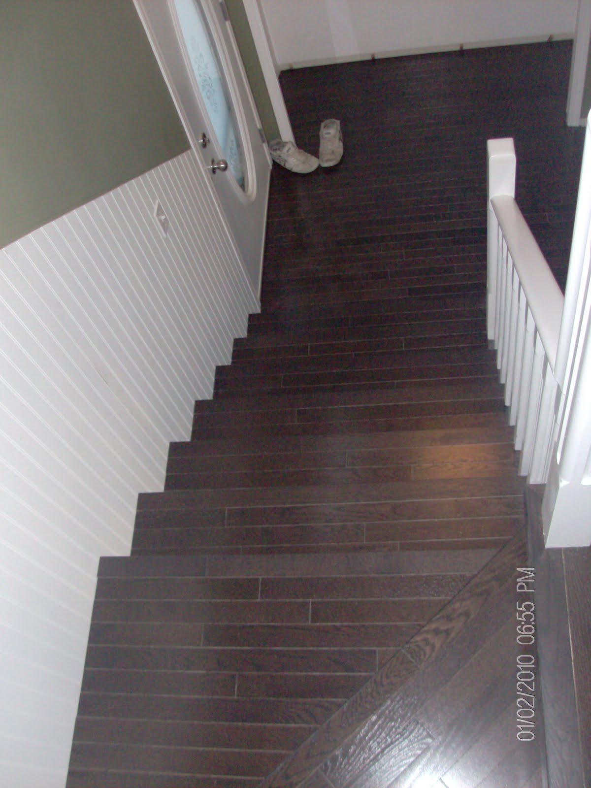 Hardwood Solutions Lethbridge Dark walnut stained oak stairs