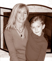 a woman and a little girl sitting by a white fireplace