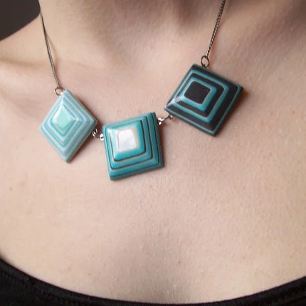 layered blue paper squares on a necklace