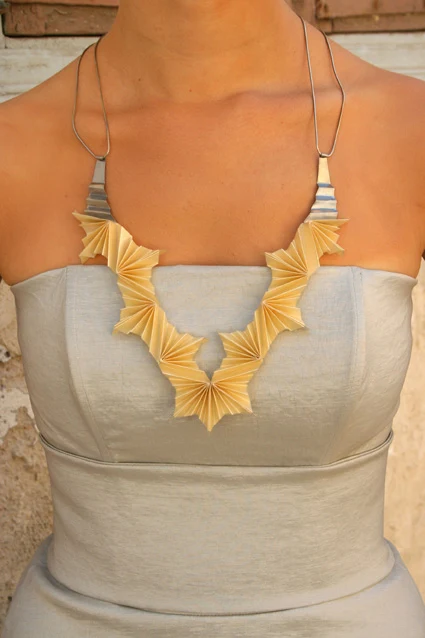 folded silver and ivory paper necklace on model