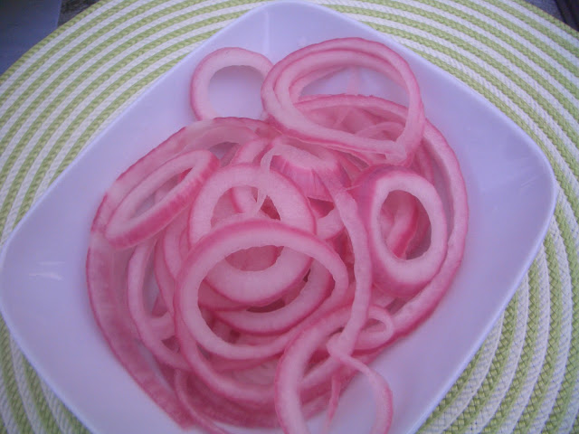 plate with pickled red onion slices