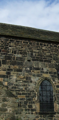 Photograph of the Saxon mass-clock on the south wall of Escombe Saxon church, near Bishop Auckland, County Durham. My photograph, April 2009.