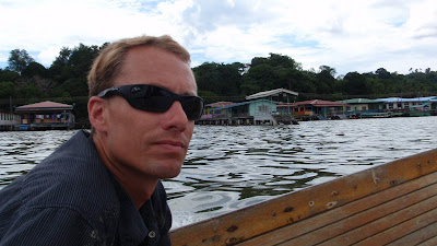 man in boat at Kampong Ayer stilt village.