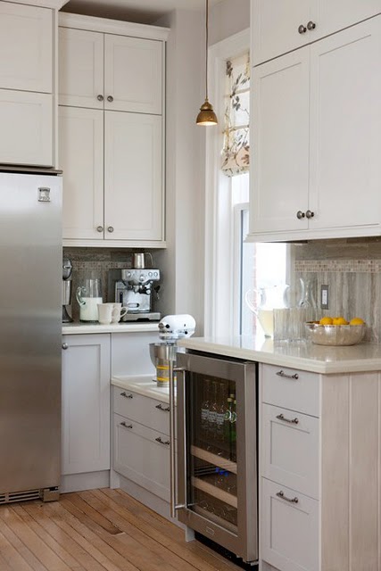 Detail of farmhouse kitchen with low window and custom cabinetry