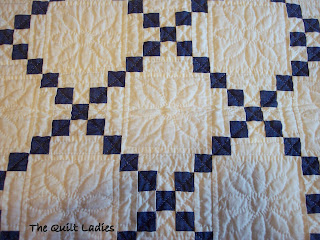 Hand quilted blue and white quilt in squares