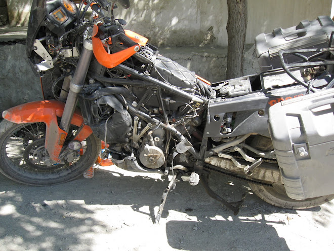 Working on the KTM on the road outside of the hotel in Mulbech