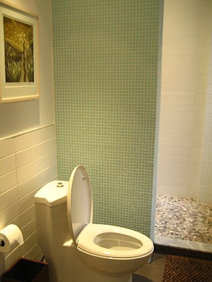 Bathroom in a NYC apartment with tiled shower and shower wall