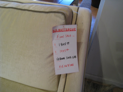 Price tag on a cream colored sofa with piping at HD Buttercup