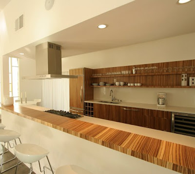 Bright open kitchen with modern amenities like exotic wood cabinets 