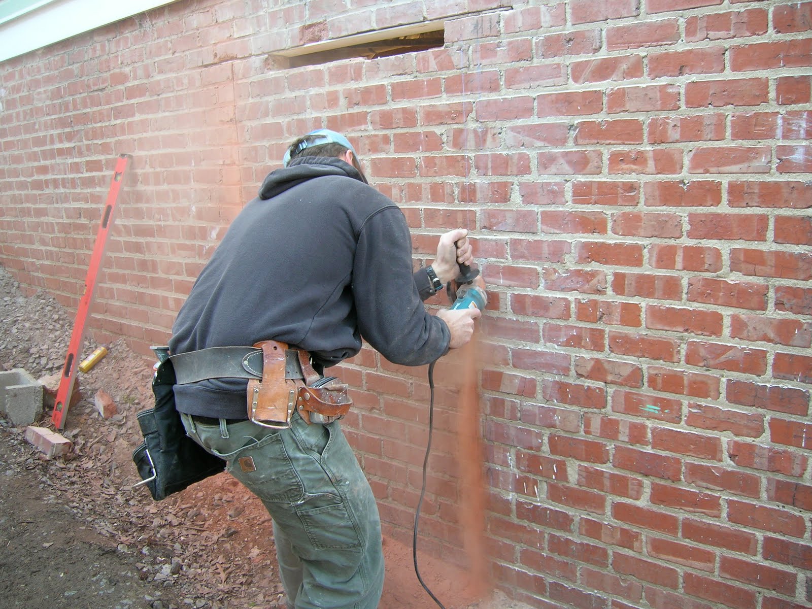 DammanWorks/Carpentry Salvaged Window Installed in Brick Wall