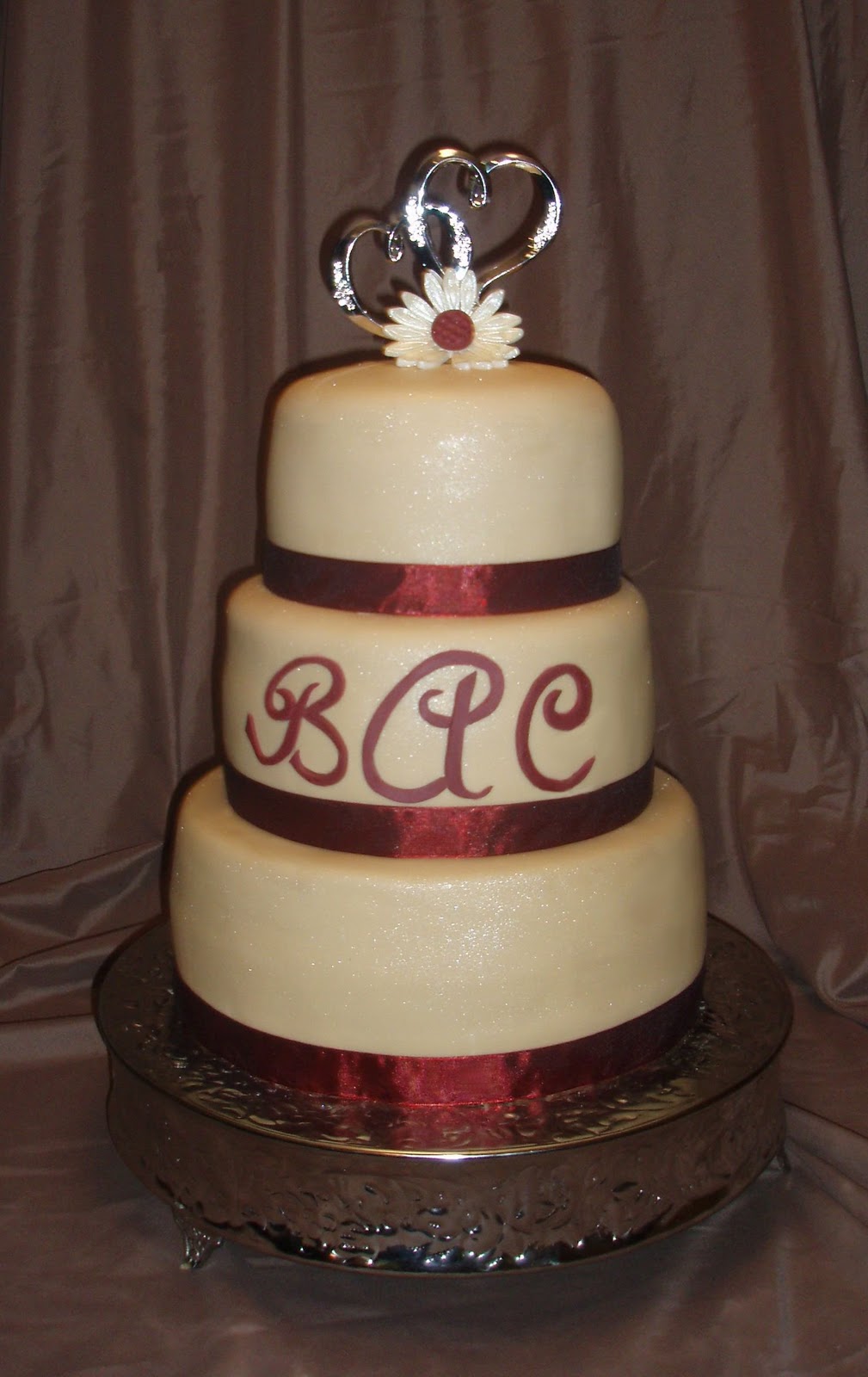 Peggy Does Cake. Champagne fondant with burgundy ribbon
