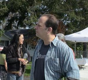 Mark Flanders and his wife Audrey Tsui chat with shoppers at the Ferndale Farmers Market