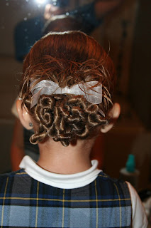 Back view of young girl modeling "Ponytail Of Twists" hairstyle