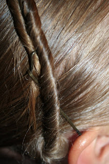 Close up view of young girl's hair being styled into "Hair Headband" hairstyle