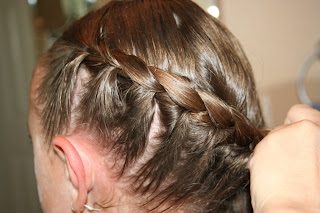 Side view of young girl's hair being styled into "Wrap-Around French Braid" hairstyle