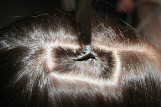 Top view of young girl having her hair styled as "teen heart" hairstyle 1