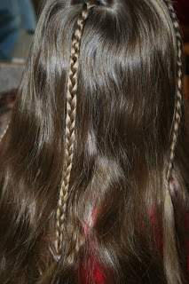 Back view of young girl's hair being styled into "Beachy Combo" hairstyle