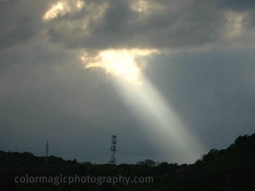 Beams of light penetrating the thick clouds above the Hoia_baciu forest