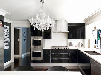 chandelier is a brilliant stroke in this<br />very modern black and white kitchen