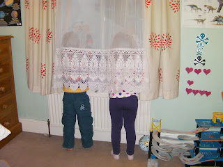invisible children hiding behind a net curtain hide and seek