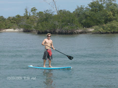 A guy on a 'Stand Up Paddle Board'.  What else could it be?