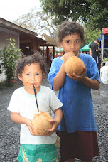 Local kids enjoying coconuts