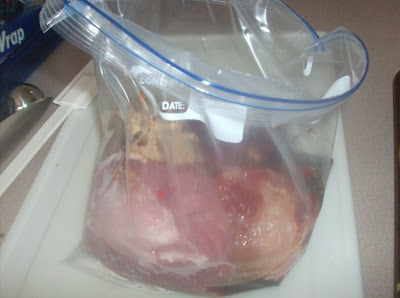 Pork chop seasoned and placed in a plastic bag.