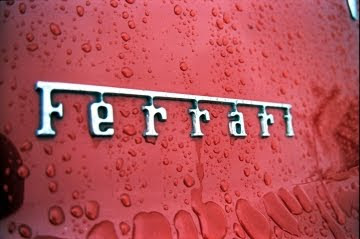 ferrari logo with rain drops on it