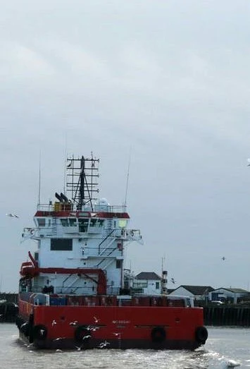 On the left, the footpath succombs to coastal erosion at Corton. On the right, a ship heads out to sea at Gorleston
