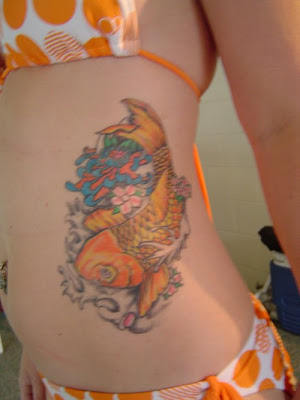 Female Tattoo With Japanese Koi Fish Tattoo Design On The Left Lower Front Body