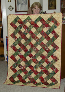 me holding my new red and green Christmas quilt