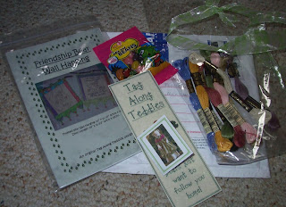 opened package of pattern, jelly beans, bookmark, card and ribbon