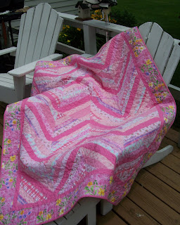 pink string quilt on chair outside