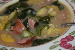 bowl of soup with sausage, beans, squash, and zucchini