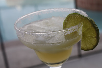 glass with margarita and salted rim and lime slice