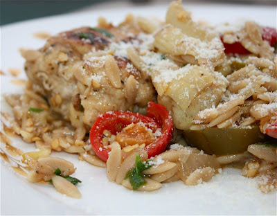 plate with chicken, artichokes, and orzo