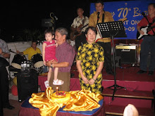 Albert Ong carrying his grandchild