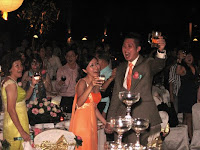 The wedding couple having a toast with his guest at the beach wedding