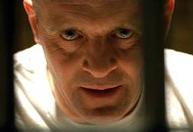 Anthony Hopkins staring menacingly through prison bars.