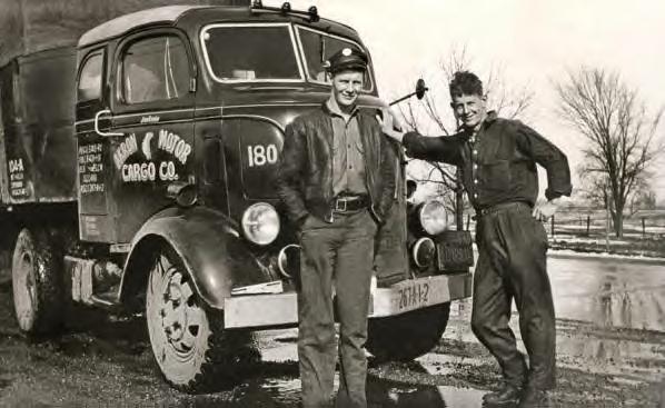 Jim Ennis and an unidentified man standing in front of an Akron Motor Cargo truck. Late 1930s