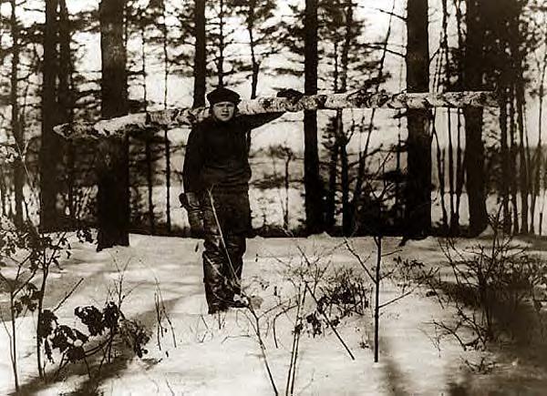Babe Ruth carrying a log. Undated
